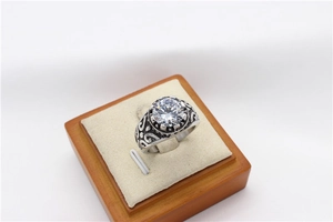 Macro shot of vintage titanium steel ring with ornate carving and large round gemstone