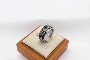 Macro shot of Viking Valknut triangle ring in vintage stainless steel with matte texture