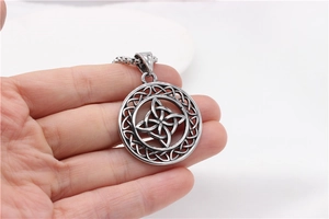 Macro detail of vintage Viking Celtic knot pendant with antique stainless steel finish
