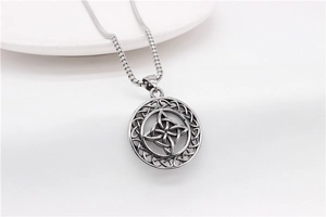 Macro detail of vintage silver Viking Celtic knot pendant with stainless steel box chain