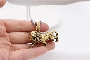 Close-up of a 3D roaring golden lion pendant necklace with a silver box chain