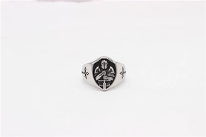 Macro shot of retro silver ring featuring a knight armor shield and cross engravings