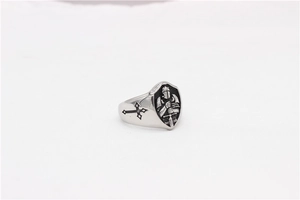 Macro view of shield-shaped ring with knight relief and cross engraving details