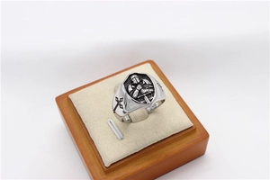 Macro detail of gothic stainless steel ring with knight relief and cross engraving
