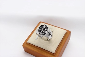 Detail view of vintage knight relief and cross design on a men's stainless steel ring