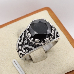 Retro stainless steel ring featuring a large faceted black gemstone and ornate scrollwork