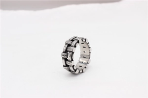 Macro detail of retro woven texture on silver steel ring with oxidized vintage finish