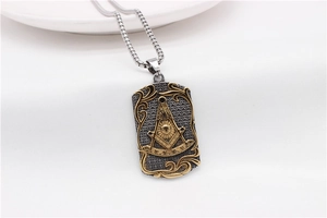 Macro view of Freemason rectangle pendant with gold filigree and square compass symbol