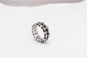 Detail showing vintage braided chain design with engraved patterns on silver steel ring