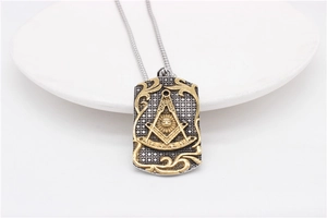 Macro detail of retro rectangular Masonic pendant with gold scrollwork and silver texture