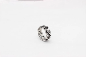 Macro detail of vintage silver ring with treble clef and Celtic knot patterns