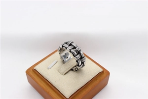 Macro detail of retro woven texture and oxidized silver finish on steel men ring