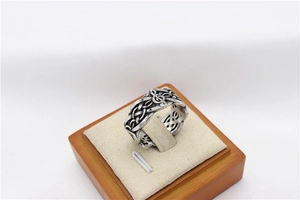 Detailed macro shot of vintage musical note pattern on a steel viking ring