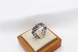Macro detail of vintage Viking ring with intricate Celtic knot hollow pattern in steel