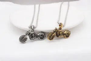 Detailed close-up of retro motorcycle pendants in silver and gold with embossed textures