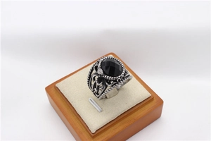 Vue macro d'une bague serpent vintage en argent avec une pierre ovale noire facettée