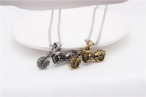 Close-up of vintage motorcycle pendants in silver and gold finish with square link chain