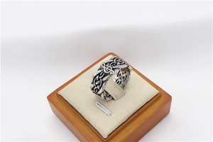 Detail of vintage musical note ring with Celtic knot patterns in distressed steel