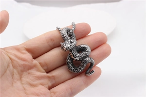 Detailed close-up of retro stainless steel snake pendant with intricate scale textures
