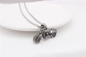 Detailed close-up of retro silver motorcycle pendant with intricate mechanical textures