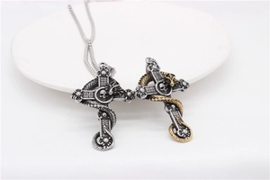 Detailed view of Gothic dragon cross pendants with skull center in silver and gold tone
