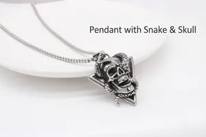 Macro shot of gothic snake and skull pendant with vintage oxidized titanium steel finish