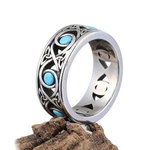 Vintage Celtic knot stainless steel ring with turquoise stones on rustic wood base