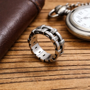 Retro men's silver stainless steel chain ring with gothic engravings on wood