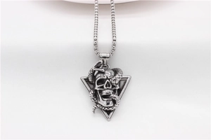 Detailed close-up of a vintage steel skull and snake pendant on a square box chain
