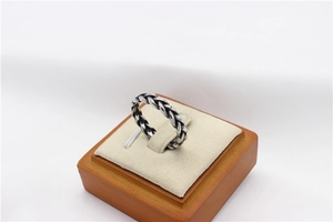 Detail view of the braided texture and vintage oxidation on a viking steel ring