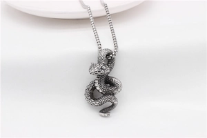 Detailed view of vintage snake pendant with intricate scales and stainless steel box chain