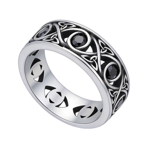 Vintage Celtic knot stainless steel ring with four round black gemstones on white background