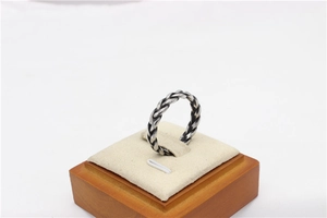 Macro detail of retro viking style braided texture on oxidized steel ring