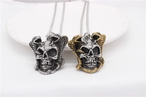 Detailed view of gothic snake and skull pendants in silver and two-tone gold finish