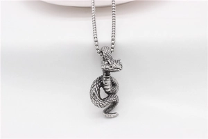 Macro detail of vintage snake pendant with intricate scales on square link chain