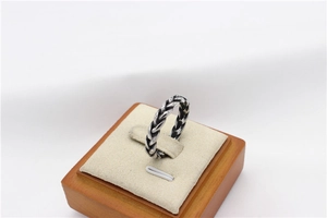 Macro detail of retro Viking style stainless steel ring with braided chain texture