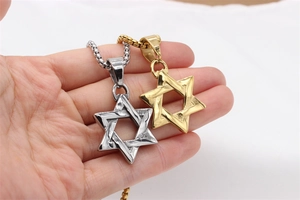 Close-up of gold and silver Star of David pendants with intricate woven texture