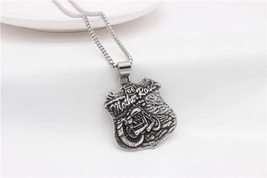 Detail of vintage silver Route 66 motorcycle rider pendant with square link chain