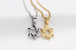 Macro view of gold and silver hexagram star pendants with polished box chain texture