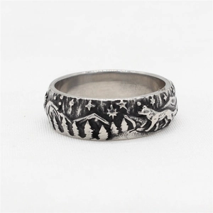 Retro stainless steel wolf ring featuring embossed forest mountains and wildlife scenery