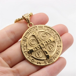 Pendentif médaille de Saint Benoît en or avec chaîne à billes sur fond blanc