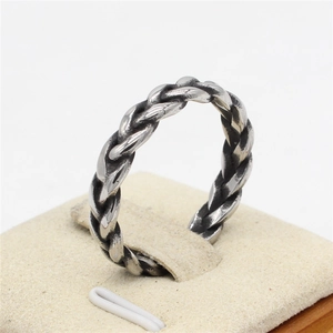 Retro Viking twisted rope ring in silver steel finish for men on a display stand