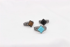 Detailed view of vintage rings featuring rhombus-cut gemstones with embossed carvings