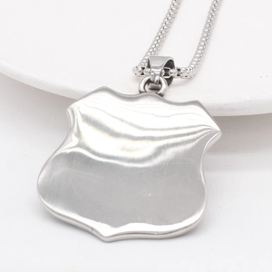 Polished stainless steel shield pendant with square foxtail chain on white background