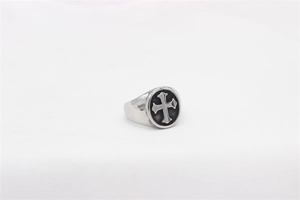 Macro detail of retro vintage cross relief on silver stainless steel biker ring band