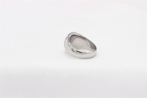 Detailed view of a wide polished stainless steel cross ring with a smooth metallic finish