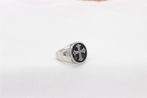 Detailed macro view of the vintage punk steel ring with a black cross emblem