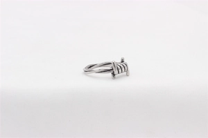 Macro detail of vintage industrial barbed wire style stainless steel ring for men