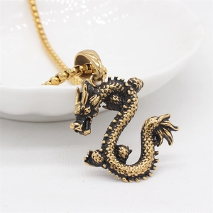 Retro golden dragon pendant necklace with detailed scales and s-shaped body on white background