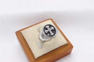 Detail of vintage gothic cross ring in silver titanium steel on a white sponge display